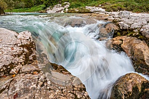 The Soca river flowing through a wild mountain landscape of the Julian Alps in Slovenia