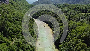 Soca Valley, Slovenia - 4K Aerial shot of white water rafting on River Soca. Whitewater rafting teams going down the River Soca