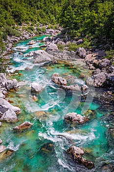 Soca Valley, Slovenia - Aerial view of the emerald alpine river Soca on a bright sunny summer day with green foliage