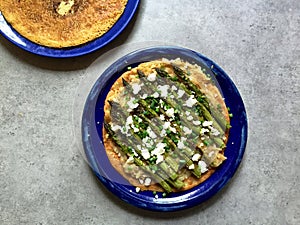 Socca (chickpea flour crepe) with asparagus, caramelized onion and feta