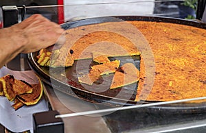 Socca, chickpea pancake cooked at a farmers market in Old Town Nice, France