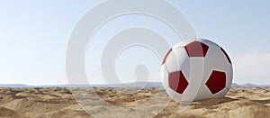 Socceer ball in white and maroon colours on the sand with blue sky. 3d render.