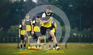 Soccer Academy For Teenagers. Youth Football Player in Strength and Agility Training. Young Boys in the Football Team At Workout