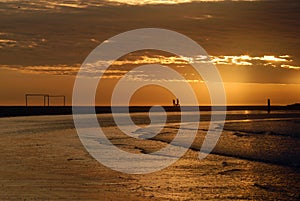 Soccer arcs on the beach at dusk