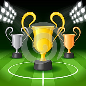 Soccer Background with Bright Spot Lights and Three Award Trophy