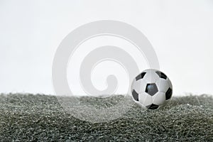 Soccer Ball on artificial grass, dark gray.