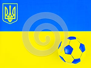 Soccer ball on the background of the national flag of Ukraine