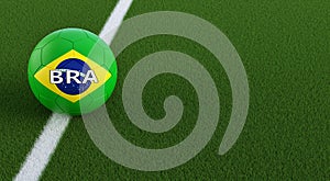 Soccer ball in brazils national colors on a soccer field. Copy space on the right side - 3D Rendering