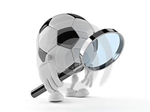 Soccer ball character looking through magnifying glass