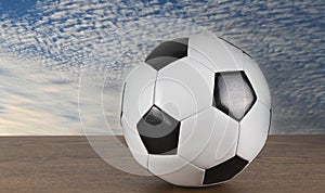 Soccer Ball with cloudy on the table and blue sky background for cheering image