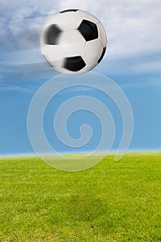 Soccer ball flying over a soccer field