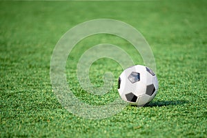 Soccer ball or football ball on green field