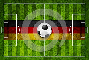 Soccer ball on football field with a German flag