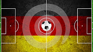 Soccer ball on football field with a German flag, motion background