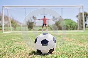Soccer ball, football field and goalkeeper ready for defense to stop goals for penalty kick game on soccer field, grass