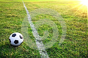 A soccer ball or football in stadium with sunset