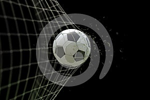 Soccer ball in goal with grass leaves that raises effect on black background, concept of competition and leisure game