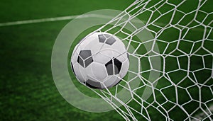 Soccer ball on goal with net and green background