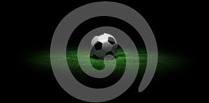 Soccer ball on grass in the dark
