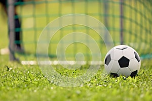 Soccer ball on the grass of football field