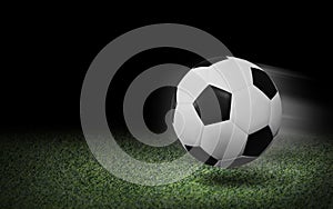Soccer ball on green grass and black background
