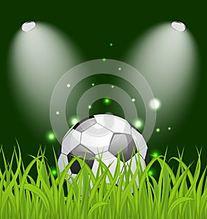 Soccer ball on green grass with light