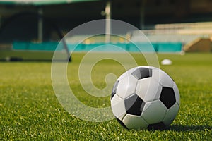 Soccer Ball on Green Grass with Stadium Background. Football Soccer Training Equipment