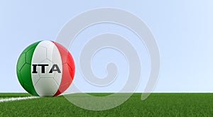 Soccer ball in italys national colors on a soccer field. Copy space on the right side - 3D Rendering photo