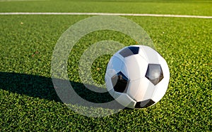 A soccer ball lying on the football pitch.