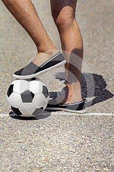 Soccer ball near the feet of a man