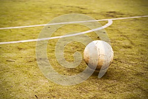 Soccer ball on the old soccer field. Yard football. Close-up