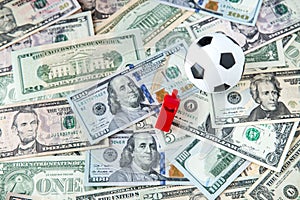 soccer ball over a lot of money. corruption football game. Betting and gambling concept. photo