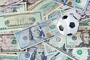Soccer ball over a lot of money. corruption football game. Betting and gambling concept. photo