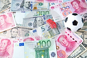 Soccer ball over a lot of money. corruption football game. Betting and gambling concept. photo