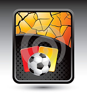 Soccer ball and penalty cards on cracked backdrop