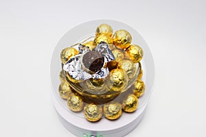 Soccer Ball-shaped chocolates in gold foil on a white background