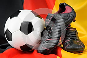 Soccer ball and shoes on German flag