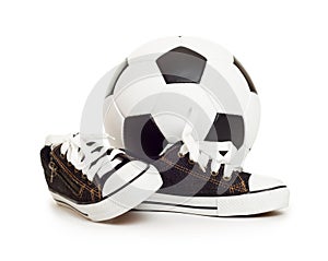 Soccer ball and sport shoes on white