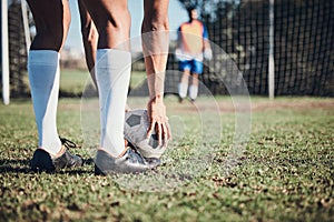 Soccer ball, sports and feet of person to kick on field, fitness training or shoot for a goal in the net. Football