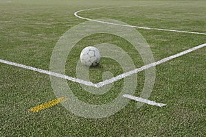 Soccer ball on sports field at boundary line