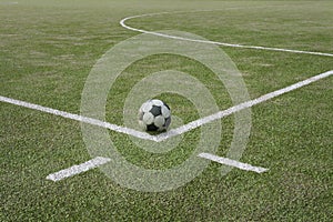 Soccer ball on sports field at boundary line