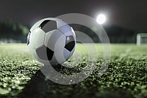 Soccer ball on sports field at night