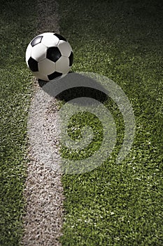 Soccer ball on sports field in stadium