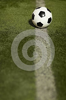 Soccer ball on sports field in stadium