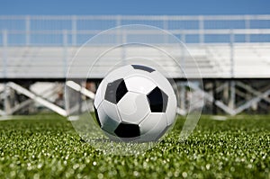 Soccer ball with stands in background