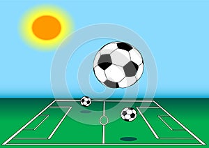 Soccer balls on field in sun
