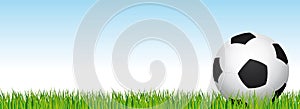 Soccer banner. Football stadium grass and blue sky background. Header with soccer ball in the right side.