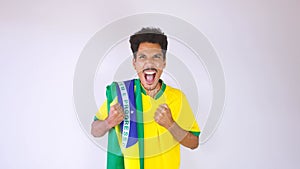 Soccer Black Man Fan or Player With Yellow Shirt and Brazil Flag Celebrating the Cup Isolated on White