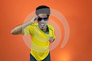 Soccer Brazilian  Fan Celebrating Isolated on Orange Background