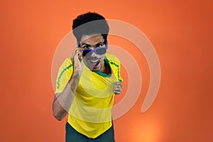 Soccer Brazilian  Fan Celebrating Isolated on Orange Background